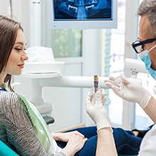 A dentist explaining how dental implants work in Evanston