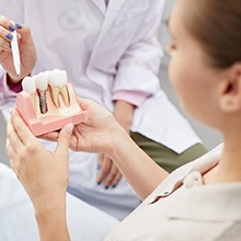 A dentist describing how dental implants work in Evanston