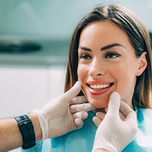A dentist assessing a patient for cosmetic dentistry