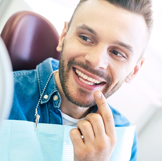 patient smiling after getting a dental bridge in Evanston
