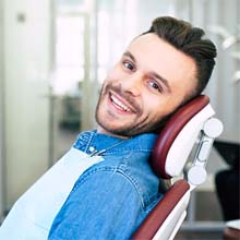 Male dental patient smiling after getting dental implants in Evanston, IL