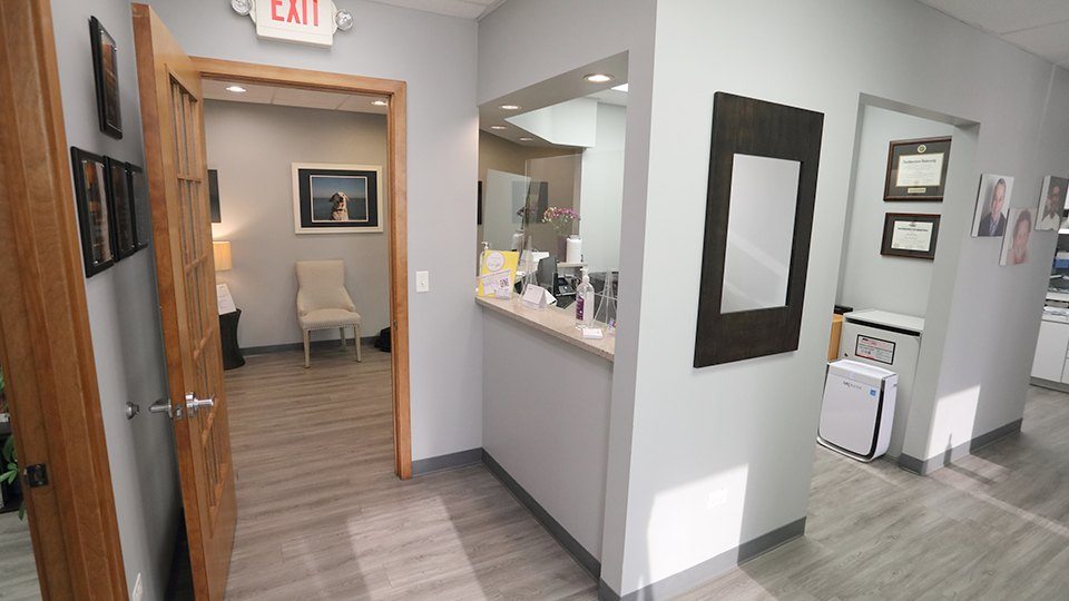 Dental office front desk and hallway leading to treatment area