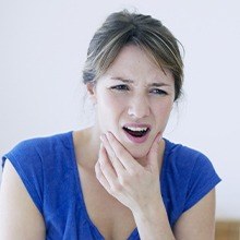 Woman with jaw pain visiting dentist for T M J diagnosis and treatment