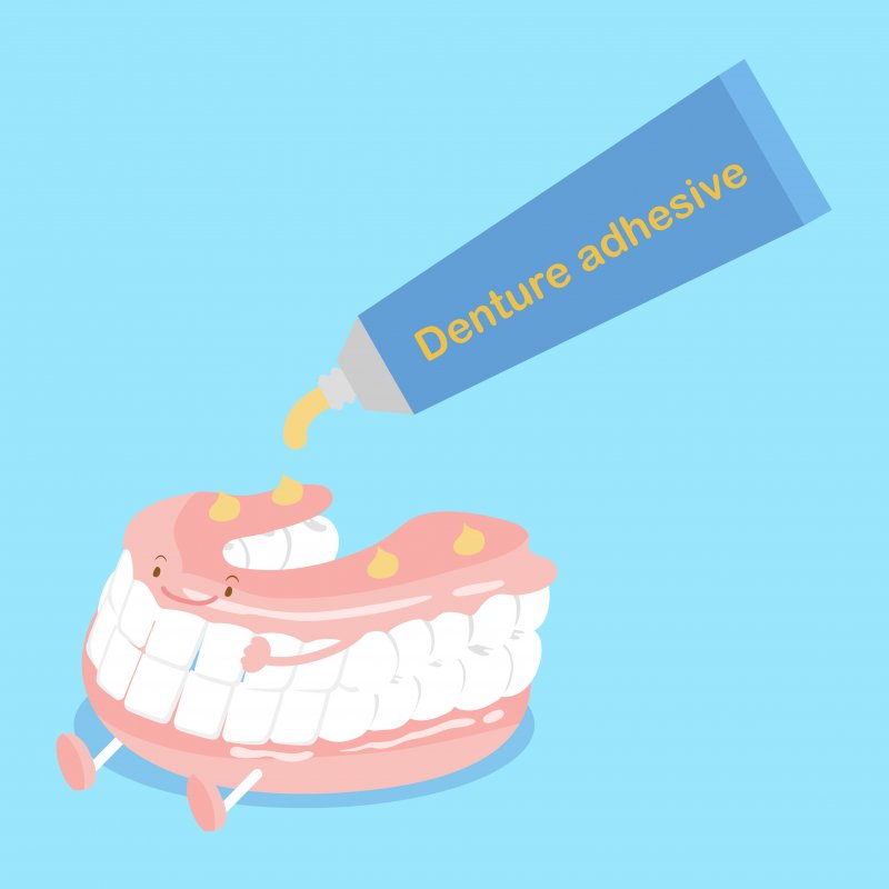 An illustration of using denture adhesive on dentures